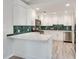 Newly renovated kitchen featuring white cabinets, quartz countertops, and a unique herringbone backsplash at 120 Arrowood Ln, Alpharetta, GA 30009