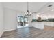 Open living room area with hardwood floors leading to an eat-in kitchen and screened-in porch at 120 Arrowood Ln, Alpharetta, GA 30009