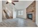 Spacious living room featuring a stone fireplace and access to the home's staircase at 120 Arrowood Ln, Alpharetta, GA 30009