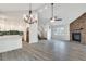 Open concept living room featuring a stone fireplace and open sight lines to the kitchen at 120 Arrowood Ln, Alpharetta, GA 30009