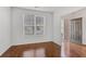 Bright entryway with gleaming hardwood floors, fresh white walls, and a view to the front door at 165 Daisy Cir, Mcdonough, GA 30252