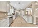 Bright, open kitchen with stainless steel appliances, granite countertops, and custom tile flooring at 203 Bent Oak Ln, Woodstock, GA 30189