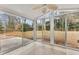 Glass enclosed sunroom featuring views of the backyard, tile flooring, and fan at 203 Bent Oak Ln, Woodstock, GA 30189