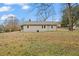 View of the home's backyard featuring a well-maintained lawn and mature trees at 207 Garrison Se Rd, Marietta, GA 30008