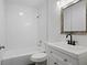 Clean bathroom features a shower/tub combo, tile surround, and a vanity with black hardware at 207 Garrison Se Rd, Marietta, GA 30008