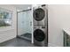 Modern bathroom with stacked washer/dryer and a glass shower with black trim at 207 Garrison Se Rd, Marietta, GA 30008
