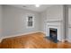 Bedroom with hardwood floors, fireplace, neutral paint, and a window with natural light at 207 Garrison Se Rd, Marietta, GA 30008