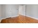 Bedroom with hardwood floors, fresh paint, and a closet with white doors at 207 Garrison Se Rd, Marietta, GA 30008
