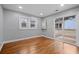 Neutral bedroom with hardwood floors, sliding glass door to patio, and two windows at 207 Garrison Se Rd, Marietta, GA 30008