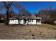 Charming one-story home featuring a covered porch and mature trees at 207 Garrison Se Rd, Marietta, GA 30008