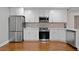 A kitchen features stainless steel appliances, white cabinets, and plenty of counter space at 207 Garrison Se Rd, Marietta, GA 30008