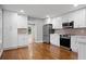 A modern kitchen with stainless steel appliances, white cabinets, and hardwood floors at 207 Garrison Se Rd, Marietta, GA 30008