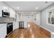 Bright kitchen features stainless appliances, white cabinets, and hardwood floors in an open floor plan at 207 Garrison Se Rd, Marietta, GA 30008