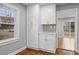 Bright pantry area with white cabinets and a view to the side yard through the window at 207 Garrison Se Rd, Marietta, GA 30008