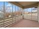 Enclosed porch with wood deck, a partial view of the backyard and adjacent properties at 207 Garrison Se Rd, Marietta, GA 30008