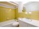 Tiled bathroom with a tub and shower combination and a white single sink vanity at 3710 Oregon Trl, Decatur, GA 30032