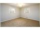 A light and airy bedroom with neutral walls and carpet at 3710 Oregon Trl, Decatur, GA 30032
