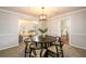 Cozy dining room with elegant chandelier and large windows adjacent to living room at 3710 Oregon Trl, Decatur, GA 30032