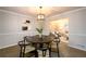 Cozy dining room with elegant chandelier and large windows adjacent to living room at 3710 Oregon Trl, Decatur, GA 30032