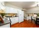 Kitchen with adjacent breakfast nook, white refrigerator and wood floors at 3710 Oregon Trl, Decatur, GA 30032