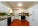 Bright kitchen features white cabinets, stainless steel appliances, and a cozy dining area at 3710 Oregon Trl, Decatur, GA 30032
