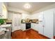 Kitchen features white cabinets, black appliances, tile backsplash, and wood floors at 3710 Oregon Trl, Decatur, GA 30032