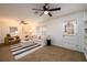 Bright living room boasts carpeted floors, white paneling, and a modern ceiling fan at 3710 Oregon Trl, Decatur, GA 30032