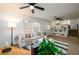 Bright living room features carpeted floors, white paneling, and a modern ceiling fan at 3710 Oregon Trl, Decatur, GA 30032