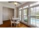 Charming breakfast nook with natural light, white table set and pool view through shuttered windows at 3931 Pinehurst Way, Duluth, GA 30096