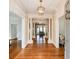 Elegant foyer featuring hardwood floors, decorative columns, and designer lighting fixtures at 3931 Pinehurst Way, Duluth, GA 30096