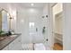 A modern bathroom featuring a glass shower and a closet with shelving for storage at 100 5Th St, Fayetteville, GA 30214