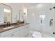 Elegant bathroom with double vanity, framed mirrors, and a glass-enclosed shower with decorative tile flooring at 100 5Th St, Fayetteville, GA 30214