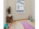 Bright bedroom with wood floors, neutral walls, and a window overlooking a charming outdoor view at 100 5Th St, Fayetteville, GA 30214