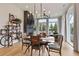 Dining area with brick fireplace, modern light fixture, and walls of windows at 100 5Th St, Fayetteville, GA 30214