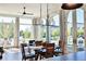 Bright dining room featuring a modern chandelier and a wall of windows with french doors leading to the outside at 100 5Th St, Fayetteville, GA 30214