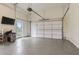 Spacious garage with an epoxy floor, tv, and an automatic door to park your vehicles at 100 5Th St, Fayetteville, GA 30214