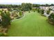 Aerial view of lush green space in a neighborhood with walking paths, pond and mature trees at 100 5Th St, Fayetteville, GA 30214