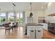 Open kitchen and dining area with stainless steel appliances and an island with bar seating at 100 5Th St, Fayetteville, GA 30214