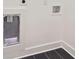 A laundry room featuring dark tile floors and white shaker cabinets at 100 5Th St, Fayetteville, GA 30214