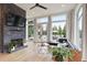 Living room with fireplace and hardwood floors. Walls of windows look out onto backyard at 100 5Th St, Fayetteville, GA 30214