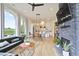 Open floor plan with modern furniture, a brick fireplace, and large windows offering natural light at 100 5Th St, Fayetteville, GA 30214