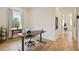 Bright home office with wood floors, large window, and a modern adjustable height desk at 100 5Th St, Fayetteville, GA 30214