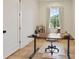 Bright home office with wood floors, large window, and a modern adjustable height desk at 100 5Th St, Fayetteville, GA 30214