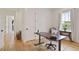 Bright home office with wood floors, large window, and a modern adjustable height desk at 100 5Th St, Fayetteville, GA 30214