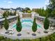 Stunning aerial view of a community pool surrounded by lounge chairs and trees in a residential neighborhood at 100 5Th St, Fayetteville, GA 30214