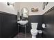 Charming powder room with black wainscoting, classic fixtures, and stylish decor at 100 5Th St, Fayetteville, GA 30214