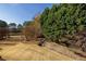 Sprawling backyard with mature trees and room for outdoor activities at 195 High Bluff Ct, Duluth, GA 30097