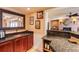 Stylish wet bar area boasts granite countertop, dark wood cabinetry and a stainless steel sink at 195 High Bluff Ct, Duluth, GA 30097