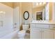 Well-lit bathroom with a bathtub, shower, toilet, white vanity with cabinets, and modern fixtures at 195 High Bluff Ct, Duluth, GA 30097