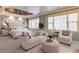 Elegant bedroom featuring a tray ceiling, neutral color palette, sitting area, and plenty of natural light at 195 High Bluff Ct, Duluth, GA 30097